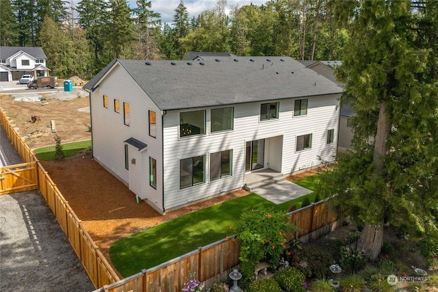 rear view of property with a patio and a yard