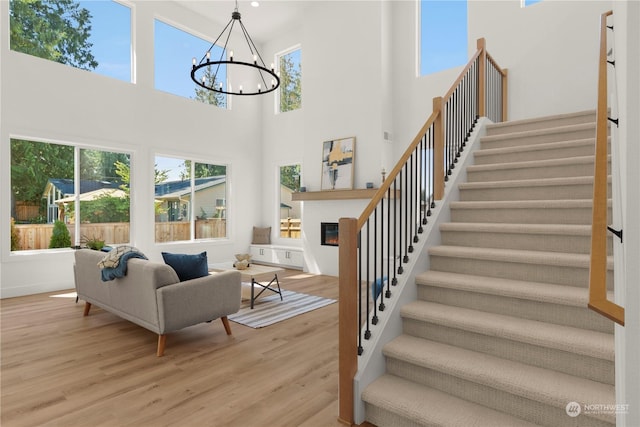 living room featuring an inviting chandelier and light hardwood / wood-style flooring