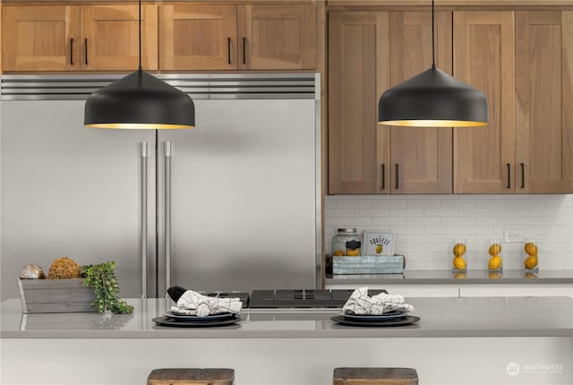 kitchen with built in refrigerator and backsplash