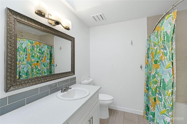 bathroom with vanity, wood-type flooring, and toilet