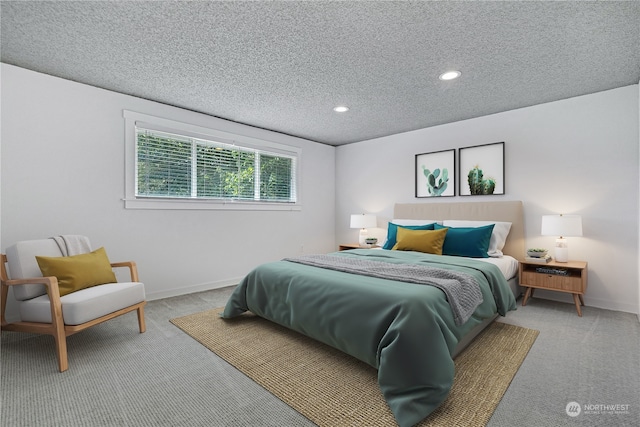 bedroom with carpet floors and a textured ceiling