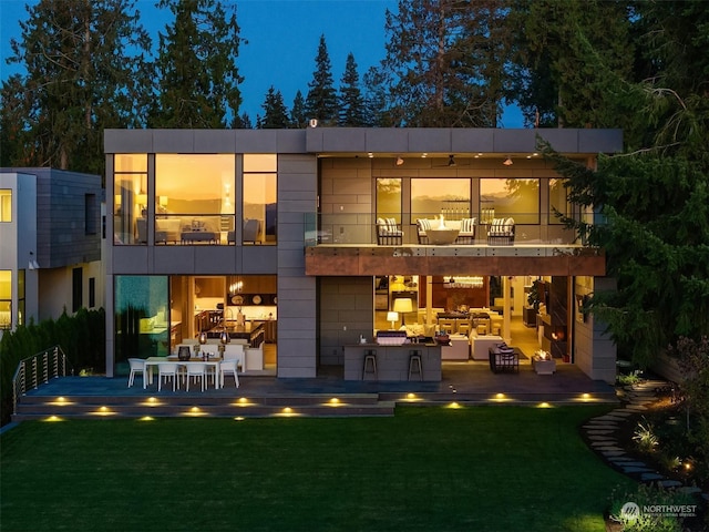 3263 Evergreen Point Rd, Medina, WA 98039 - back of house at twilight with a balcony and a yard
