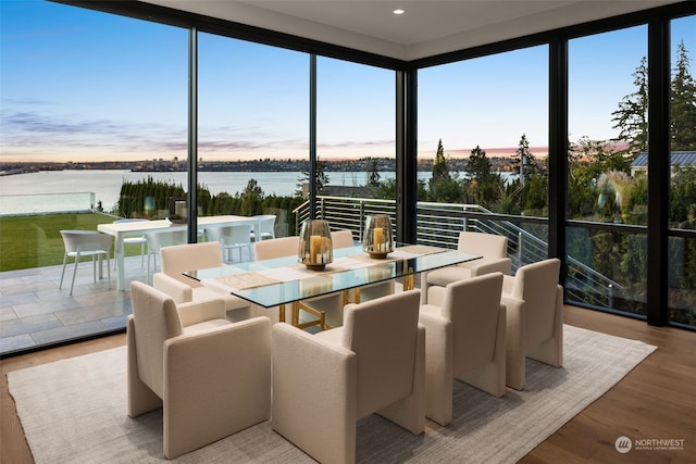 sunroom featuring a water view