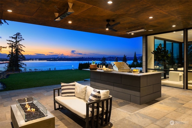3263 Evergreen Point Rd, Medina, WA 98039 - view of patio / terrace featuring exterior kitchen, a water view, an outdoor living space with a fire pit, an outdoor bar, and a ceiling fan
