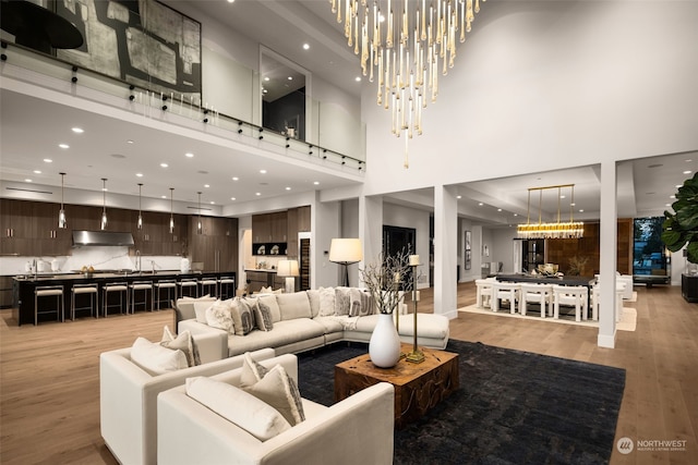 3263 Evergreen Point Rd, Medina, WA 98039 - living area with a high ceiling, a chandelier, light wood-type flooring, and recessed lighting