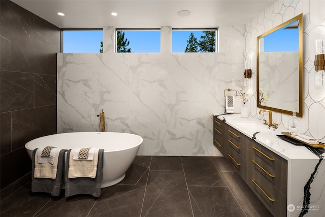 3263 Evergreen Point Rd, Medina, WA 98039 - bathroom featuring marble tiled flooring, vanity, tile walls, a soaking tub, and healthy amount of natural light