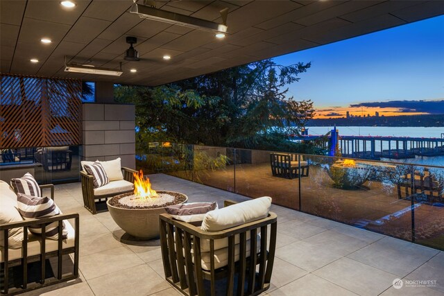 3263 Evergreen Point Rd, Medina, WA 98039 - view of patio / terrace with a water view and an outdoor living space with a fire pit