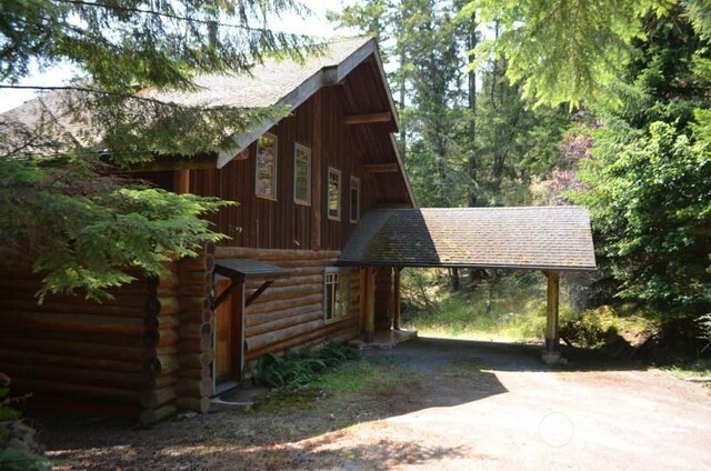 view of side of home with a carport