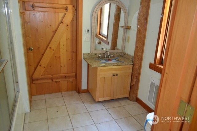 bathroom with vanity and tile patterned flooring