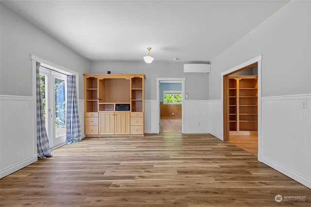 unfurnished living room with french doors and hardwood / wood-style flooring