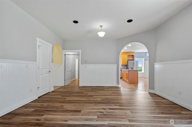 6340 Chuckanut Dr, Bow, WA 98232 - interior space featuring a wainscoted wall, arched walkways, and wood finished floors