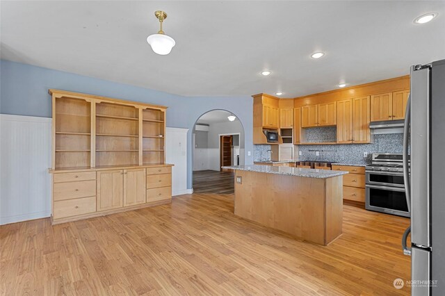 6340 Chuckanut Dr, Bow, WA 98232 - kitchen with arched walkways, light wood-type flooring, open shelves, a center island, and stainless steel appliances