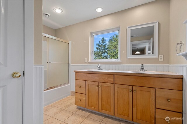 bathroom with double vanity, combined bath / shower with glass door, and tile patterned floors