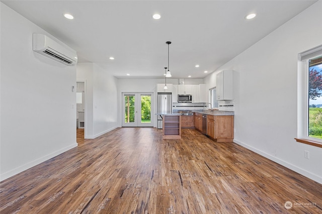 6340 Chuckanut Dr, Bow, WA 98232 - kitchen with recessed lighting, a wall mounted AC, appliances with stainless steel finishes, baseboards, and dark wood-style floors
