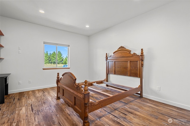 bedroom with dark hardwood / wood-style floors