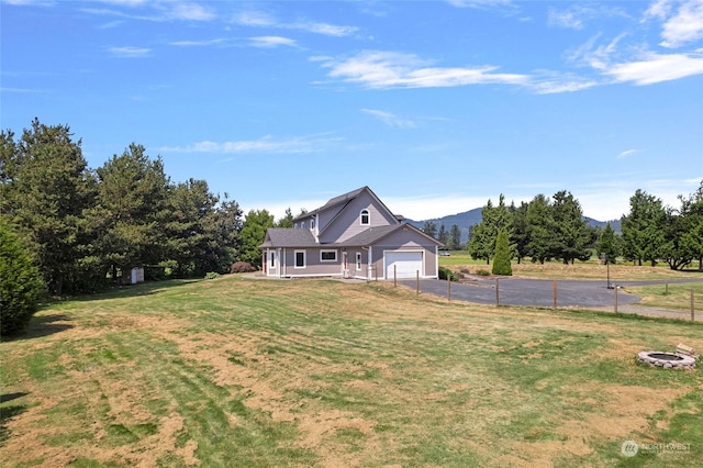 6340 Chuckanut Dr, Bow, WA 98232 - view of yard featuring a mountain view, aphalt driveway, a garage, and fence