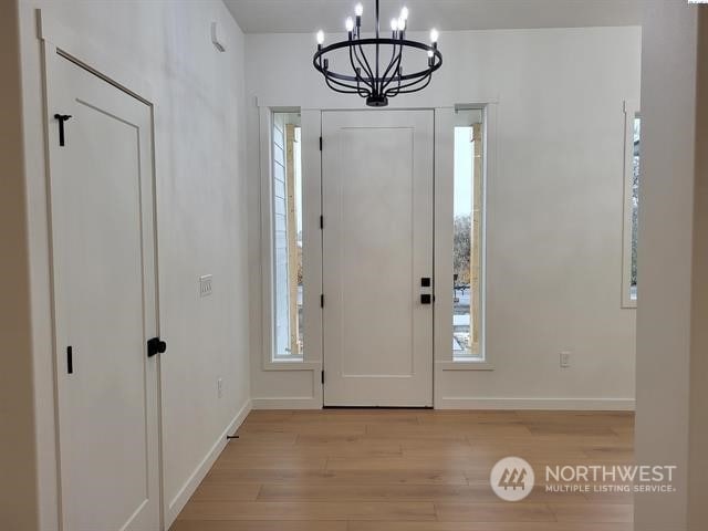 entrance foyer featuring a chandelier and light hardwood / wood-style floors