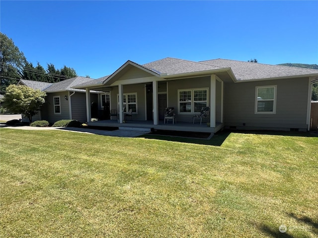 rear view of property with a yard