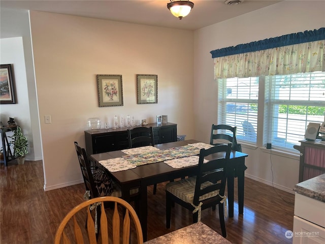 dining area with dark wood-type flooring