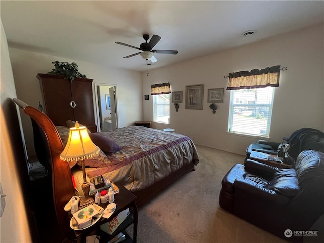 carpeted bedroom with ceiling fan and multiple windows