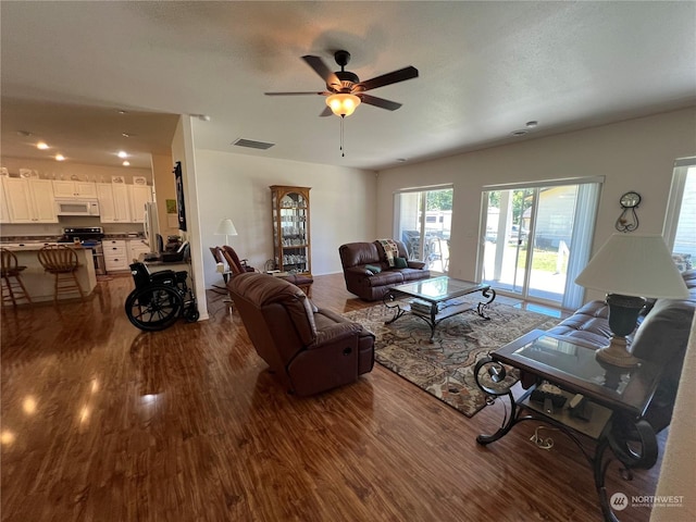 living room with hardwood / wood-style floors and ceiling fan