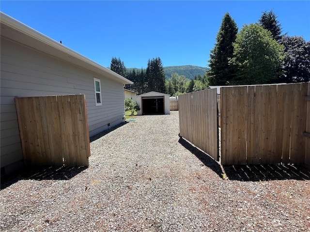 view of side of property with an outdoor structure and a mountain view