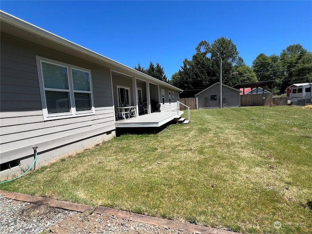 view of yard with a wooden deck and an outdoor structure