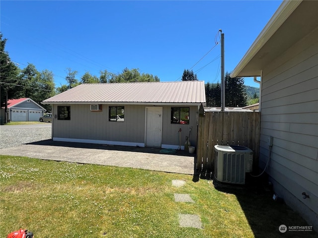 exterior space with central AC unit and a front yard