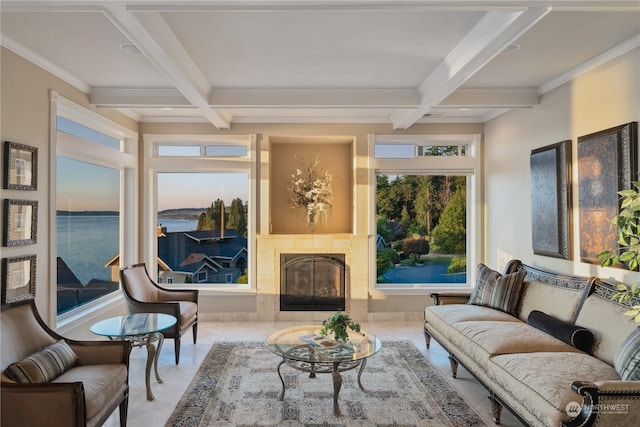 interior space featuring coffered ceiling, a tiled fireplace, beamed ceiling, and a water view