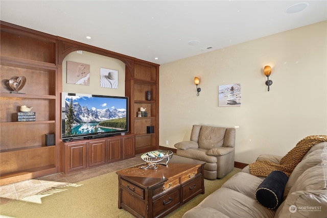 living room with built in shelves and light colored carpet