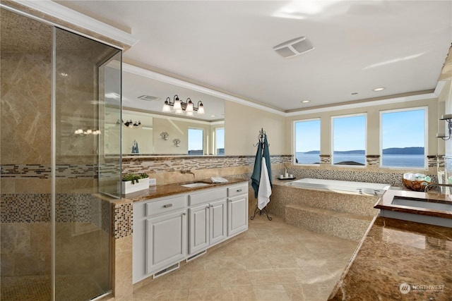 bathroom with vanity, ornamental molding, shower with separate bathtub, and a water view