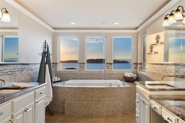 bathroom featuring crown molding, tile patterned floors, vanity, and tiled bath