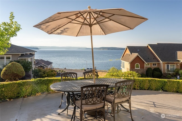 view of patio with a water view