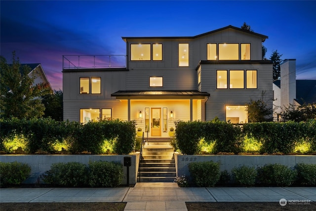 modern home featuring covered porch