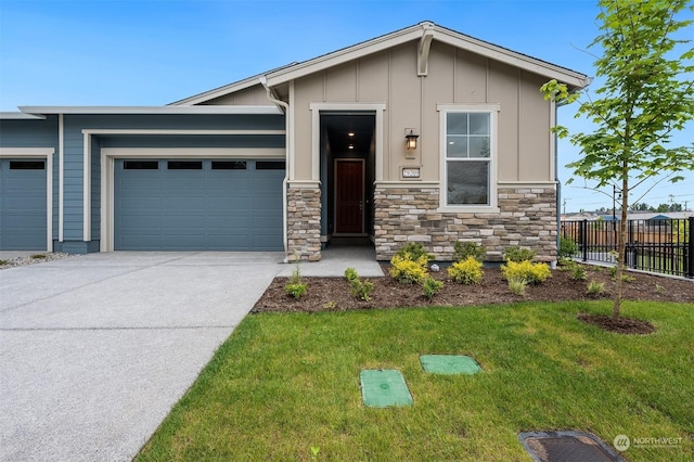 29209 217th Pl SE Unit 30, Black Diamond, WA 98010 - view of front of property with a front yard, an attached garage, stone siding, fence, and concrete driveway