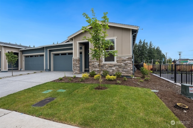 29209 217th Pl SE Unit 30, Black Diamond, WA 98010 - view of front facade featuring an attached garage, stone siding, fence, a front lawn, and driveway