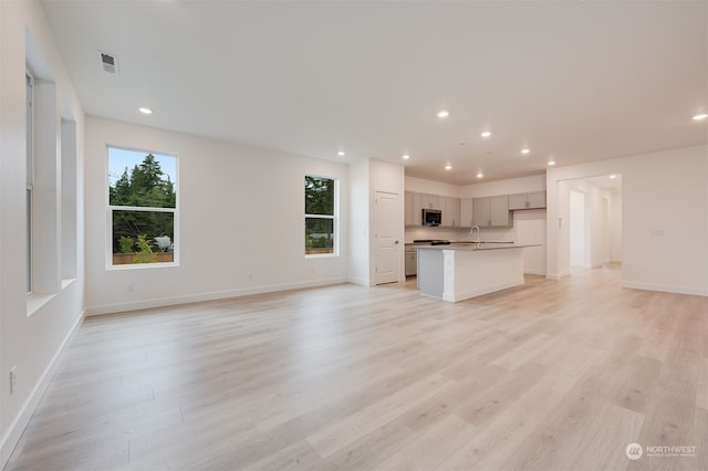 29209 217th Pl SE Unit 30, Black Diamond, WA 98010 - unfurnished living room with a wealth of natural light, light wood finished floors, and recessed lighting