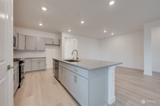 29209 217th Pl SE Unit 30, Black Diamond, WA 98010 - kitchen featuring dishwasher, a sink, recessed lighting, black gas range, and light wood-style flooring