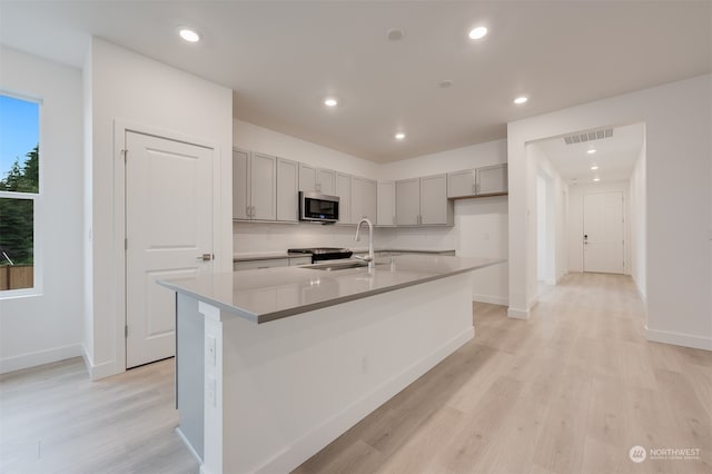 29209 217th Pl SE Unit 30, Black Diamond, WA 98010 - kitchen featuring gray cabinets, stainless steel microwave, a sink, and visible vents