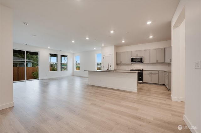 29209 217th Pl SE Unit 30, Black Diamond, WA 98010 - kitchen with tasteful backsplash, gray cabinets, open floor plan, stainless steel appliances, and a sink