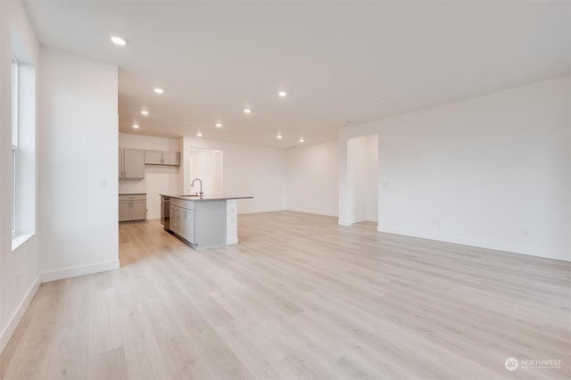 29209 217th Pl SE Unit 30, Black Diamond, WA 98010 - unfurnished living room featuring recessed lighting, light wood-style flooring, baseboards, and a sink