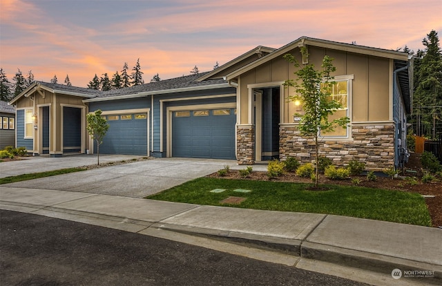 29209 217th Pl SE Unit 30, Black Diamond, WA 98010 - view of front of property with a garage, driveway, board and batten siding, and stone siding