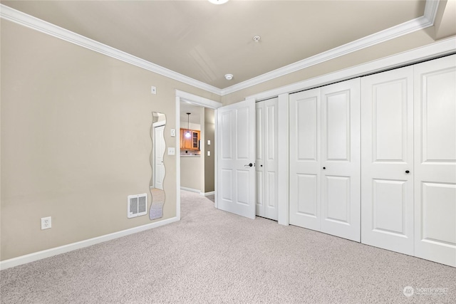 unfurnished bedroom with crown molding and light colored carpet