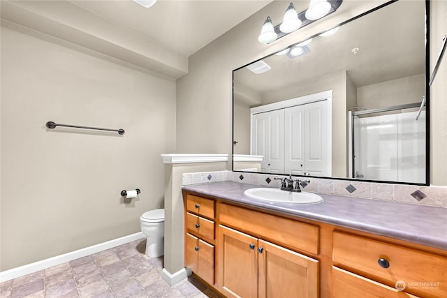 bathroom featuring vanity, toilet, and walk in shower