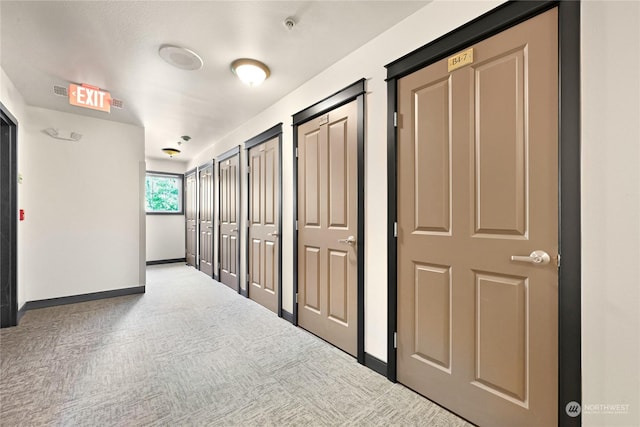 hall featuring carpet flooring