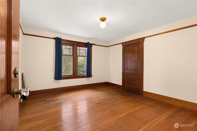 unfurnished room featuring wood-type flooring