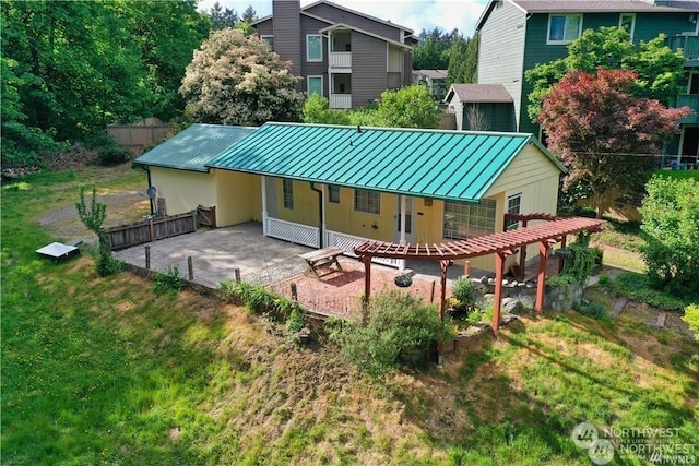 back of property featuring a patio and a lawn