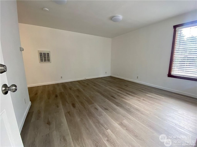 empty room featuring hardwood / wood-style flooring