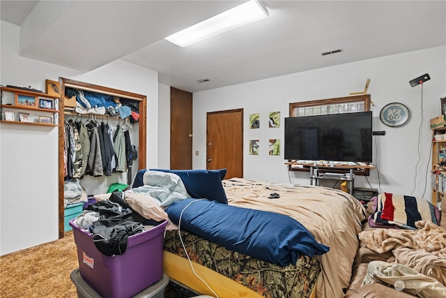 bedroom with carpet and a closet