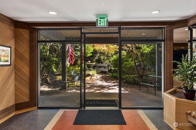 doorway featuring wooden walls